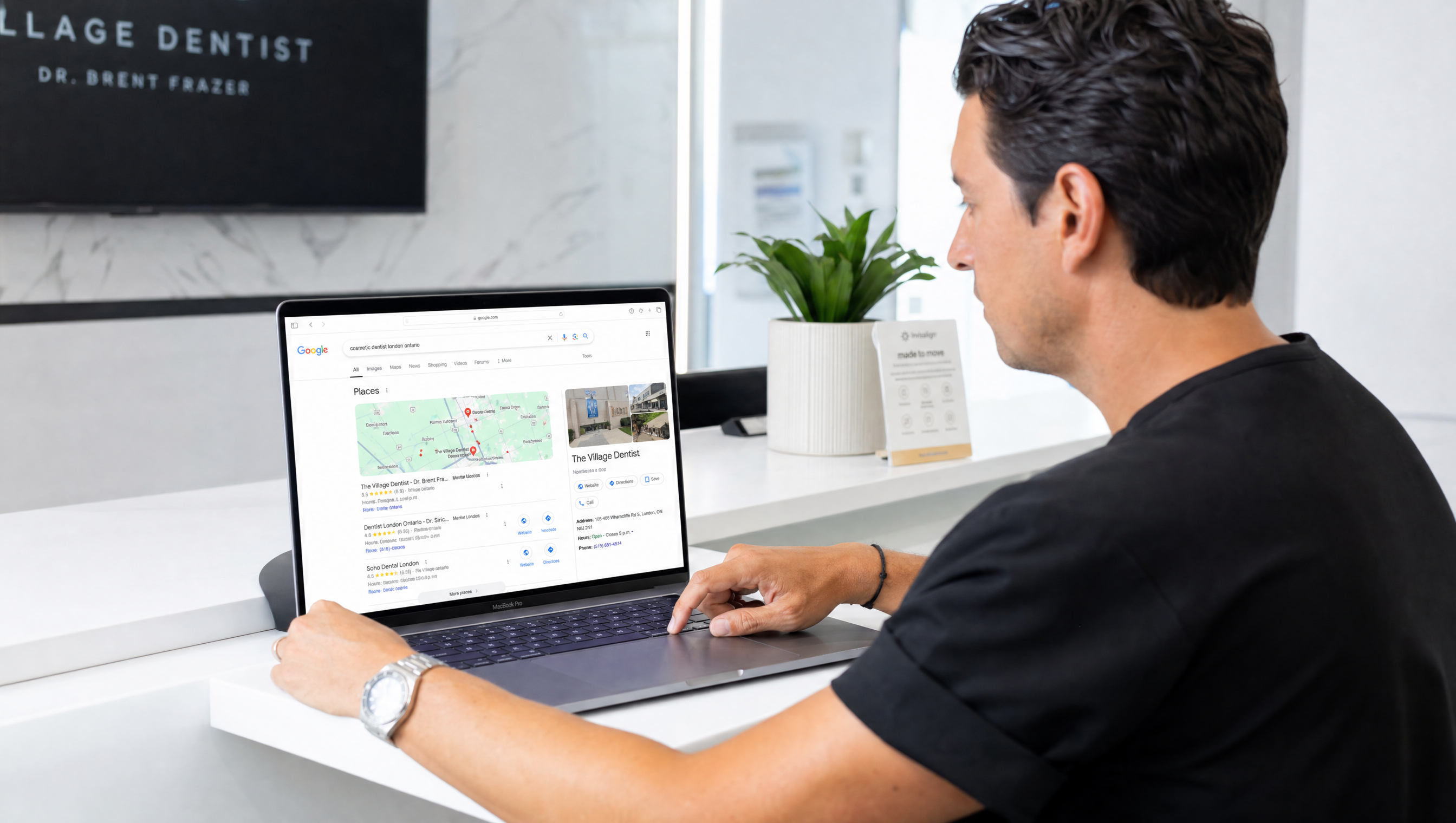 Dentist reviewing local SEO rankings on laptop in modern London Ontario dental clinic